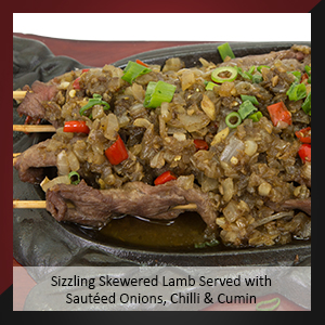 Sizzling Skewered Lamb Served with Sautéed Onions, Chilli & Cumin